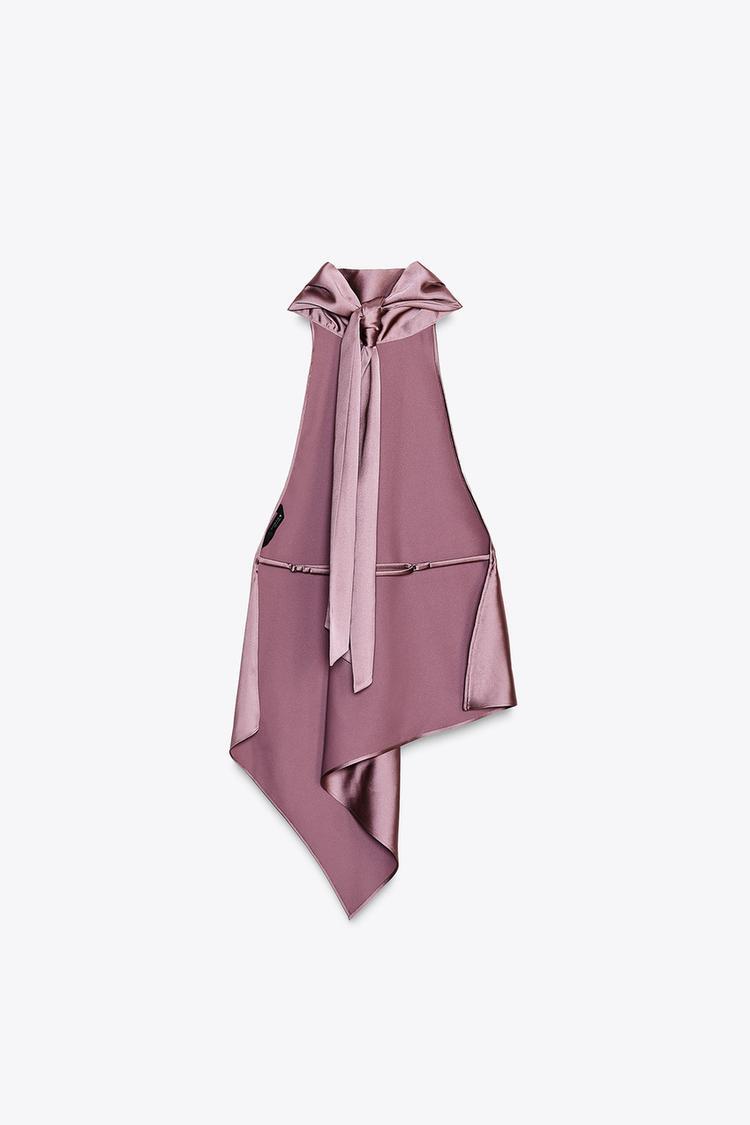 Pink sleeveless top with a bow detail on a white background