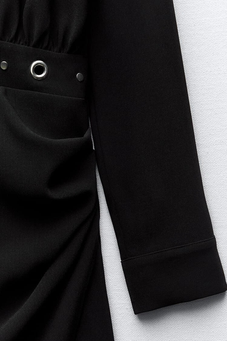 Close-up of a black long-sleeve garment with a pocket on a white background
